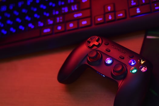 KHARKOV, UKRAINE - MAY 12, 2022 Gamesir g3s video game controller and a4tech keyboard on office table photo