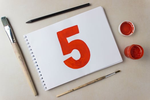 Red number five drawing on a white album sheet. To indicate the place, price, etc. photo