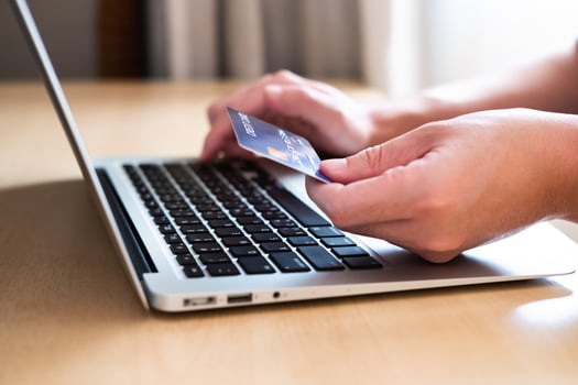 Men hand holding credit card and type payment information on keyboard for order online shopping. Internet technology and Digital market place E-Commerce lifestyle concept, Purchase transaction. photo