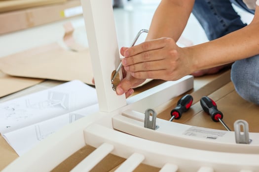 Man assembling white chair furniture at home photo