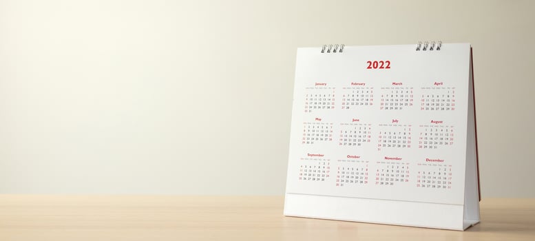 Close up 2022 calendar page dates and month background business planning appointment meeting concept photo
