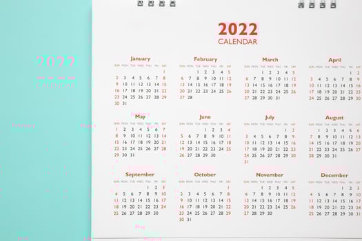 2022 calendar page on blue background business planning appointment meeting concept photo