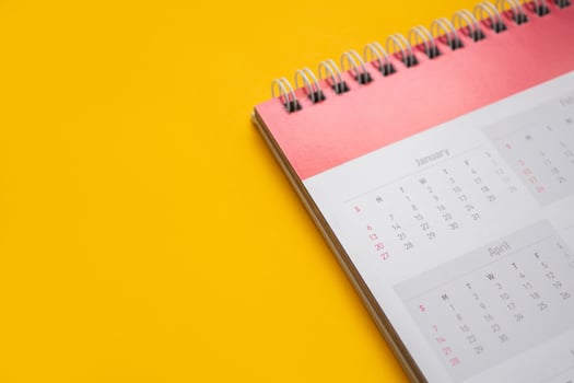 calendar page on yellow background business planning appointment meeting concept photo