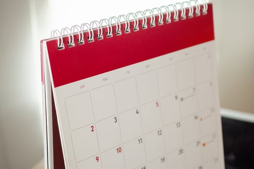Calendar page close up with white wall background business planning appointment meeting concept photo