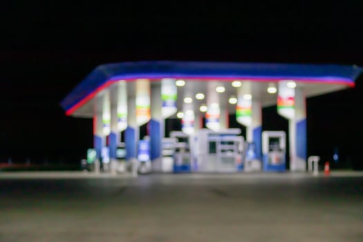 Petrol gas station at night time blurred background with bokeh light photo