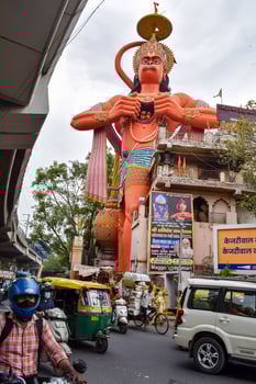 New Delhi, India - June 21, 2022 - Big statue of Lord Hanuman near the delhi metro bridge situated near Karol Bagh, Delhi, India, Lord Hanuman big statue touching sky photo