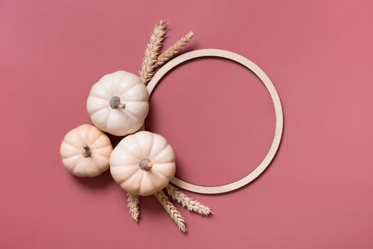 Decorative pumpkins and wooden frame for text, autumn themed blank top view, flat lay photo