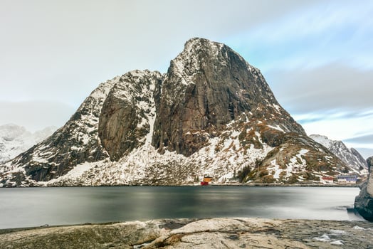 Fishing hut in the Hamnoy and Lilandstinden mountain peak in winter in Reine, Lofoten Islands, Norway. photo