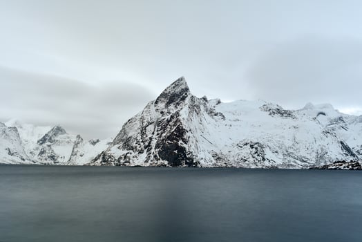 Fishing hut in the Hamnoy and Lilandstinden mountain peak in winter in Reine, Lofoten Islands, Norway. photo