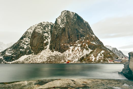 Fishing hut in the Hamnoy and Lilandstinden mountain peak in winter in Reine, Lofoten Islands, Norway. photo