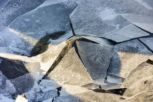 Rock cracking through the ice in Boosen in the Lofoten Islands, Norway in the winter. photo