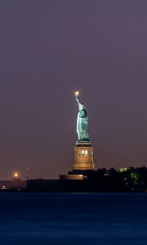 Statue of Liberty at night from Battery Park, New York City photo