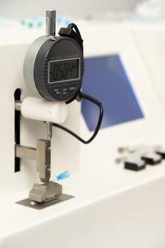 A vertical closeup shot of equipment in a medical laboratory for manufacturing medical syringes photo