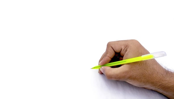 Man's hand holding pen and writing on virtual screen isolated on white background photo