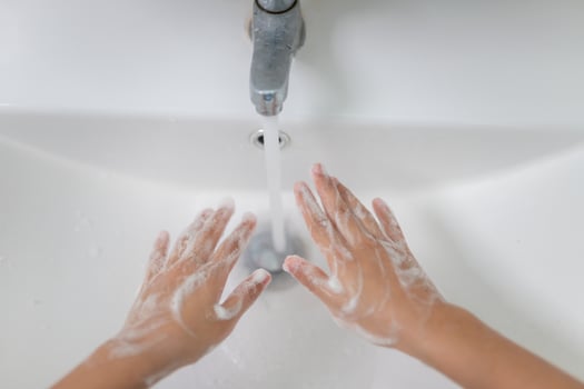 Little Asian girls wash their hands in the bathroom. Soft focus. Copy space. photo