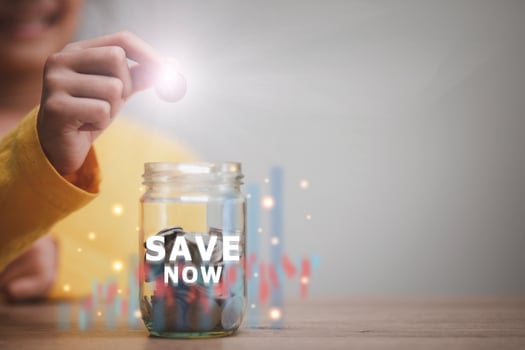 business finance saving and investment concept. hand put money coin into the glass for saving money wealth photo