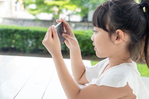 Little girl using smartphone, Social media concept. photo