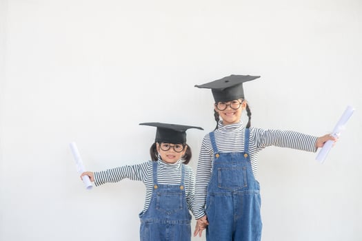 Siblings children girl graduation with cap and diploma over white. photo