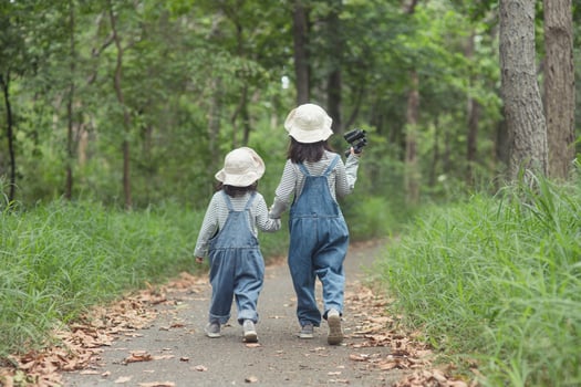 Children are heading to the family campsite in the forest Walk along the tourist route. Camping road. Family travel vacation concept. photo