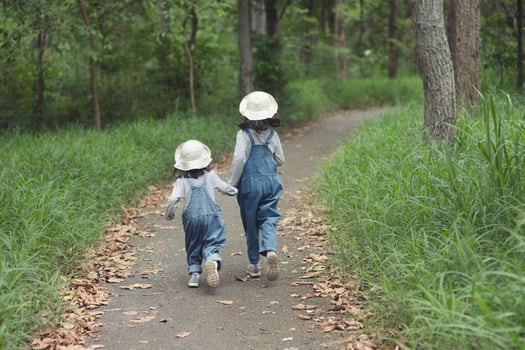Children are heading to the family campsite in the forest Walk along the tourist route. Camping road. Family travel vacation concept. photo