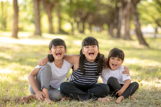 Group of kindergarten kids friends arm around and smiling fun With sunset photo