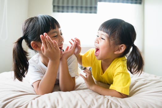 Cute asian children lying on the bed photo