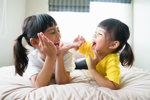 Cute asian children lying on the bed photo