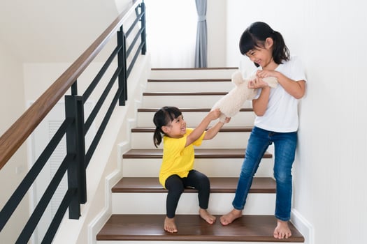 two little girl fighting over bear photo