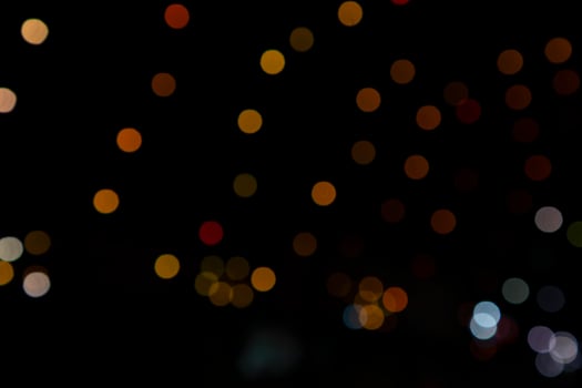 Colorful Defocus Abstract bokeh light effects on the night black background texture photo