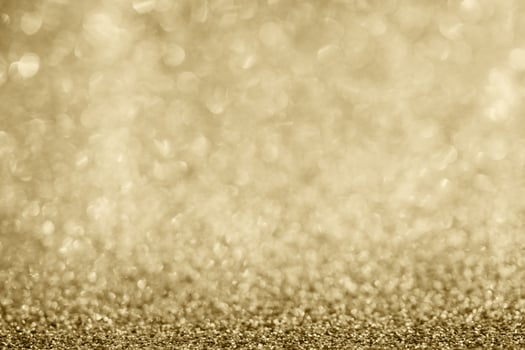 Abstract gold glitter sparkle blurred with bokeh background photo