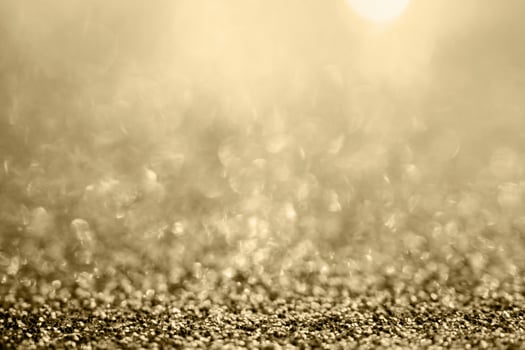 Abstract gold glitter sparkle blurred with bokeh background photo
