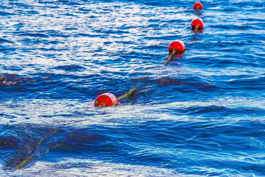 Blue water waves and ocean with buoy and ropes Mexico. photo