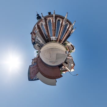 Little planet and spherical aerial 360 panorama view on street ancient medieval city with church and historic buildings photo
