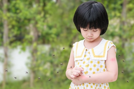 Little girl has skin rash allergy itching and scratching on her arm with mosquitoes bite photo