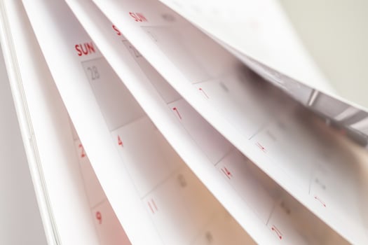 Calendar page flipping sheet close up blur background business schedule planning appointment meeting concept photo