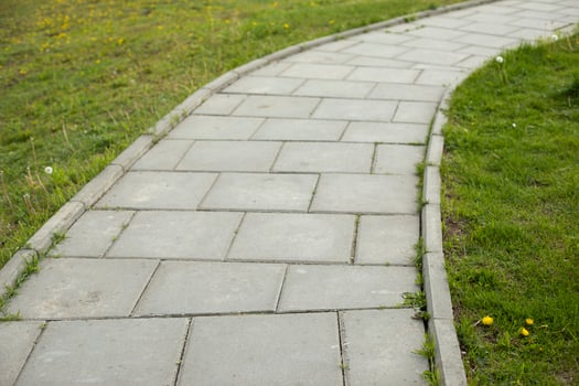 Path in park. Tile trail through park. Details of pedestrian zone. Place for walking. photo