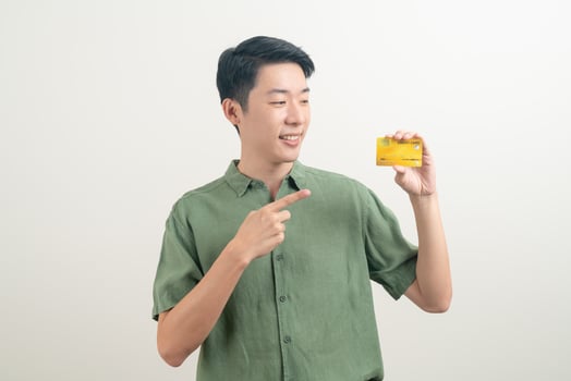 young Asian man holding credit card photo