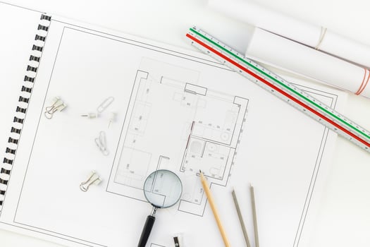 Interior designer table workplace with house plan photo