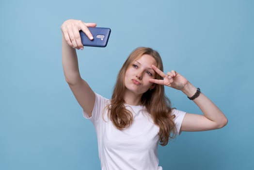 Portrait happy friendly young caucasian girl in white t-shirt on blue photo