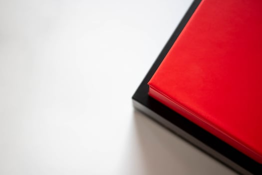 Two boxes red and black in a stack on a white background. Place for your text photo