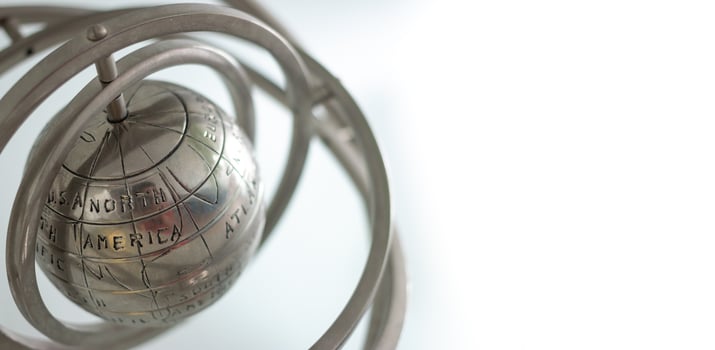 The silver metal globe shows the Americas on a white background. photo