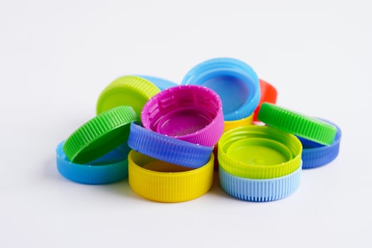 Plastic bottle caps colorful for recycle on white background. photo