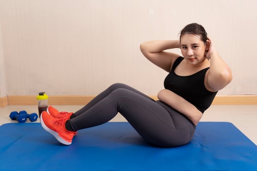 Beautiful fat Asian woman exercising at home. Sports motivation and healthy lifestyle. sports concept, training endurance, Healthy weight loss photo