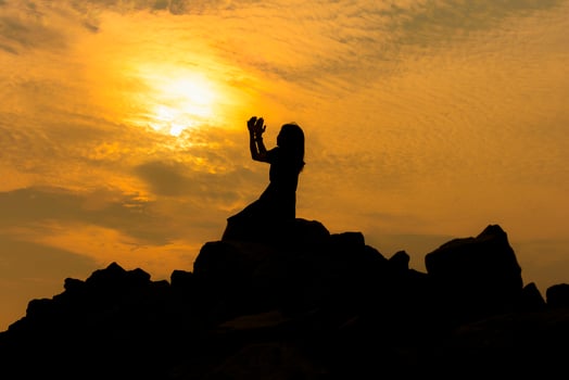 Silhouette sad girl at sunset. photo