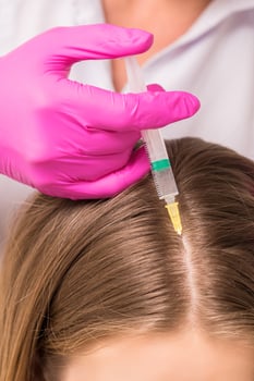 Woman receives injection in head photo
