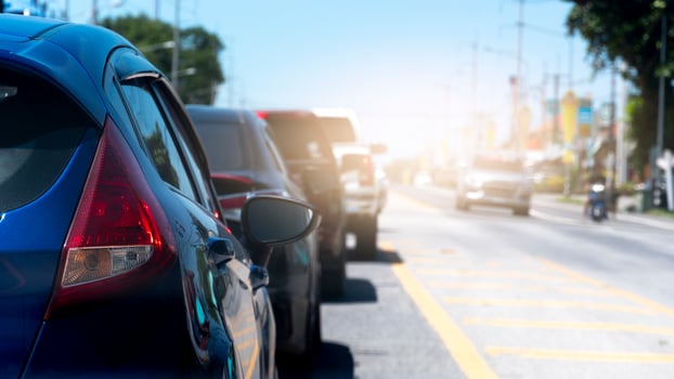 Close up tail light of blue car. Cars lined up in an orderly queue on asphalt roads. Clear traffic on the other side during daytime. Countriy road of Thailand. photo