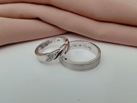 White gold wedding ring. couple ring with glossy and doff finishing with brown cloth background and white base photo