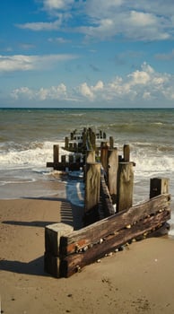 Traditional wooden beach groyne photo