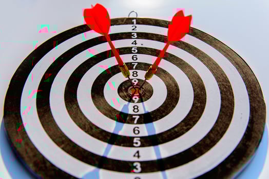Two dart hit it's target on a red background, concept for success, photo