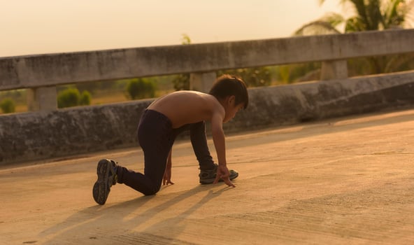 A strong little boy ran along the bridge. photo